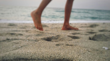 Close up image of someone walking on the beach