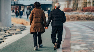 Older couple walking in the steets of a city on a cool day