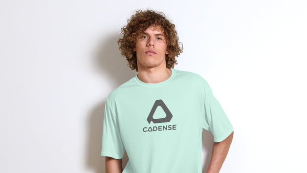 Young man standing wearing a teal Cadense Pacemaker Performance T-Shirt