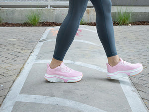 Woman walking with pink adaptive sneakers