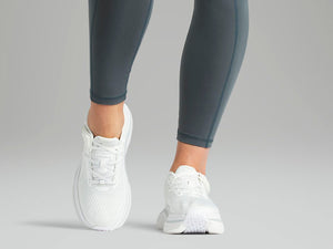 Cadense White Adaptive Shoes worn by a woman