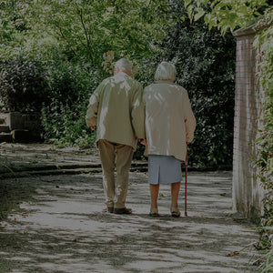 Elderly couple walking outside
