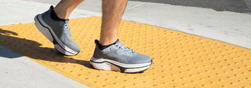 Man walking in gray adaptive shoes