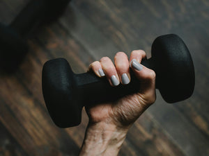 Close up photo of a hand holding a dumbbell