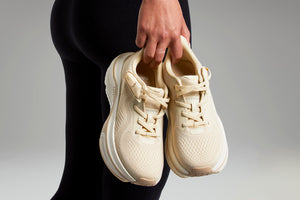 Woman holding Champagne Colored Cadense Sneakers