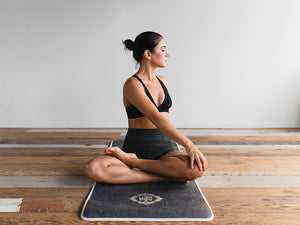 Woman sitting in a lotus pose yoga stretch