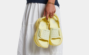 Woman holding yellow sandals