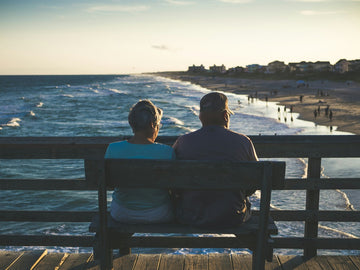 elderly couple sitting on a bench
