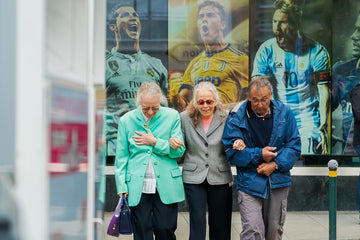 Three elderly people walking together