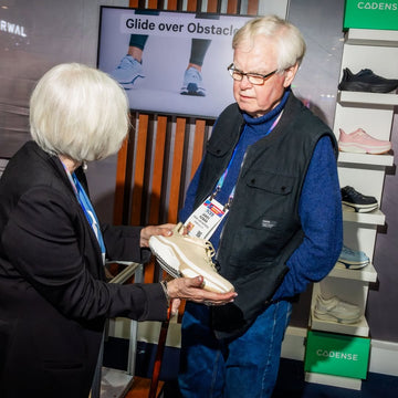 Woman describing what Cadense shoes do to an older man