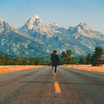 Beautiful outdoor setting and woman is running on the road