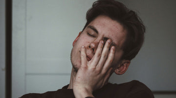 Man holding his face