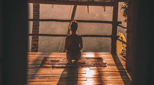 Young Woman Meditating as the sun rises