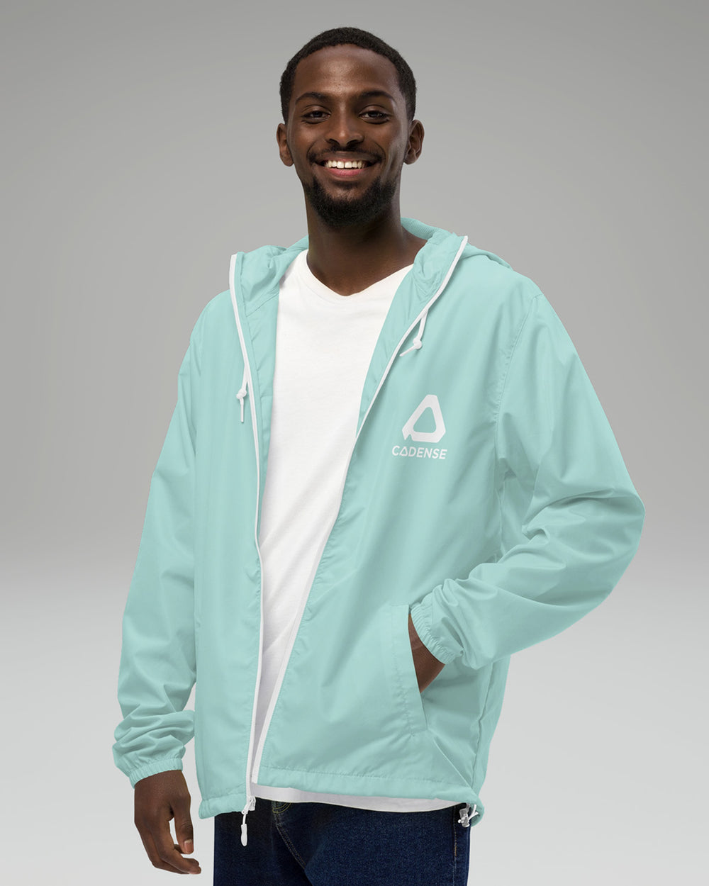[color: aqua] Young male adult wearing the aqua-colored Cadense Airwave Windbreaker.