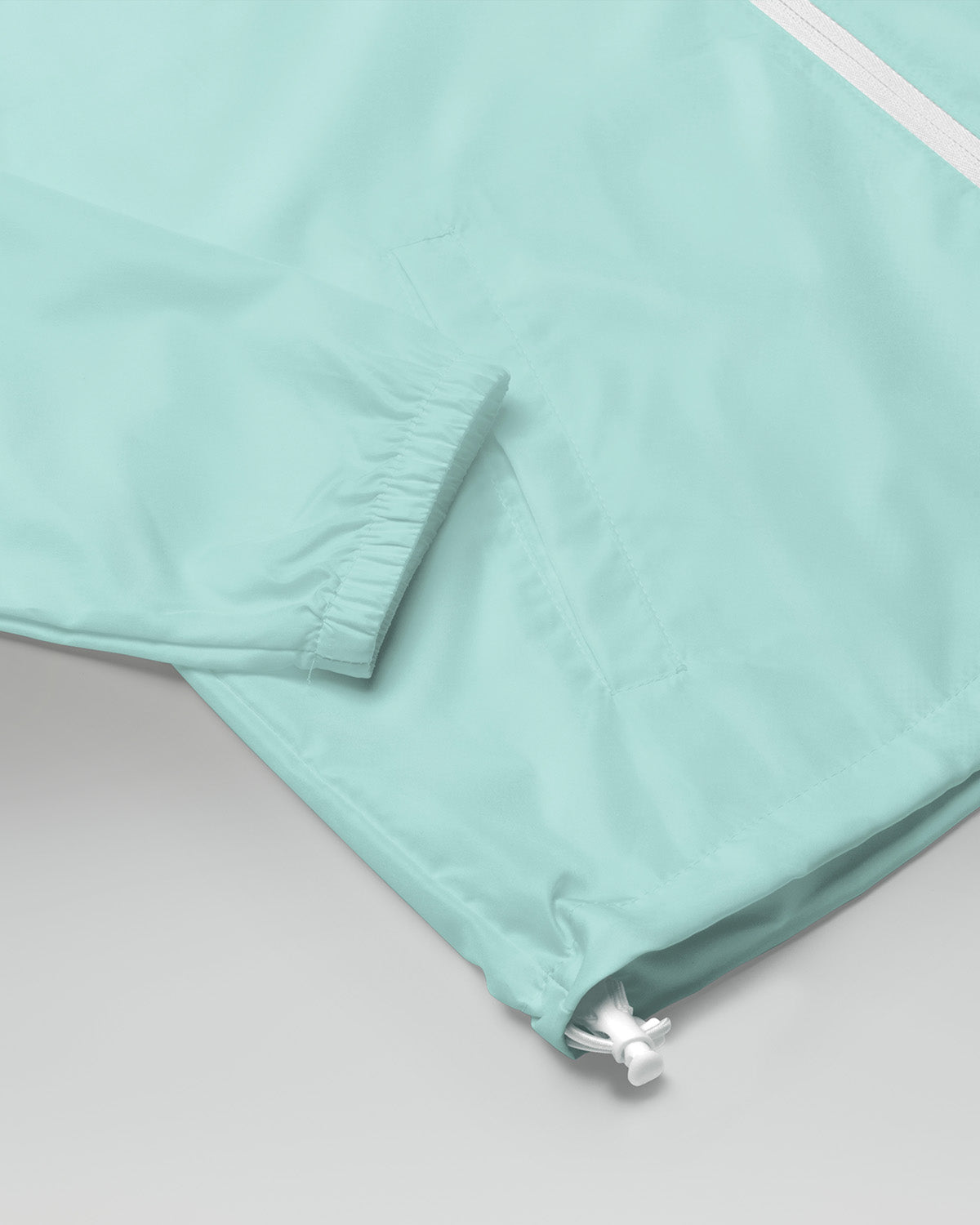 [color: aqua] Sleeve of qua-colored Cadense Airwave Windbreaker.