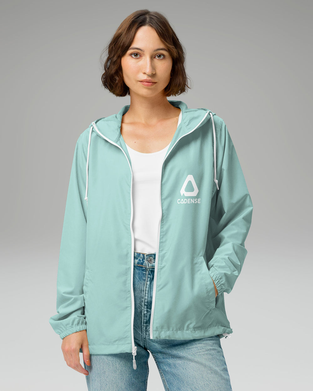 [color: aqua] Young female adult wearing the aqua-colored Cadense Airwave Windbreaker.