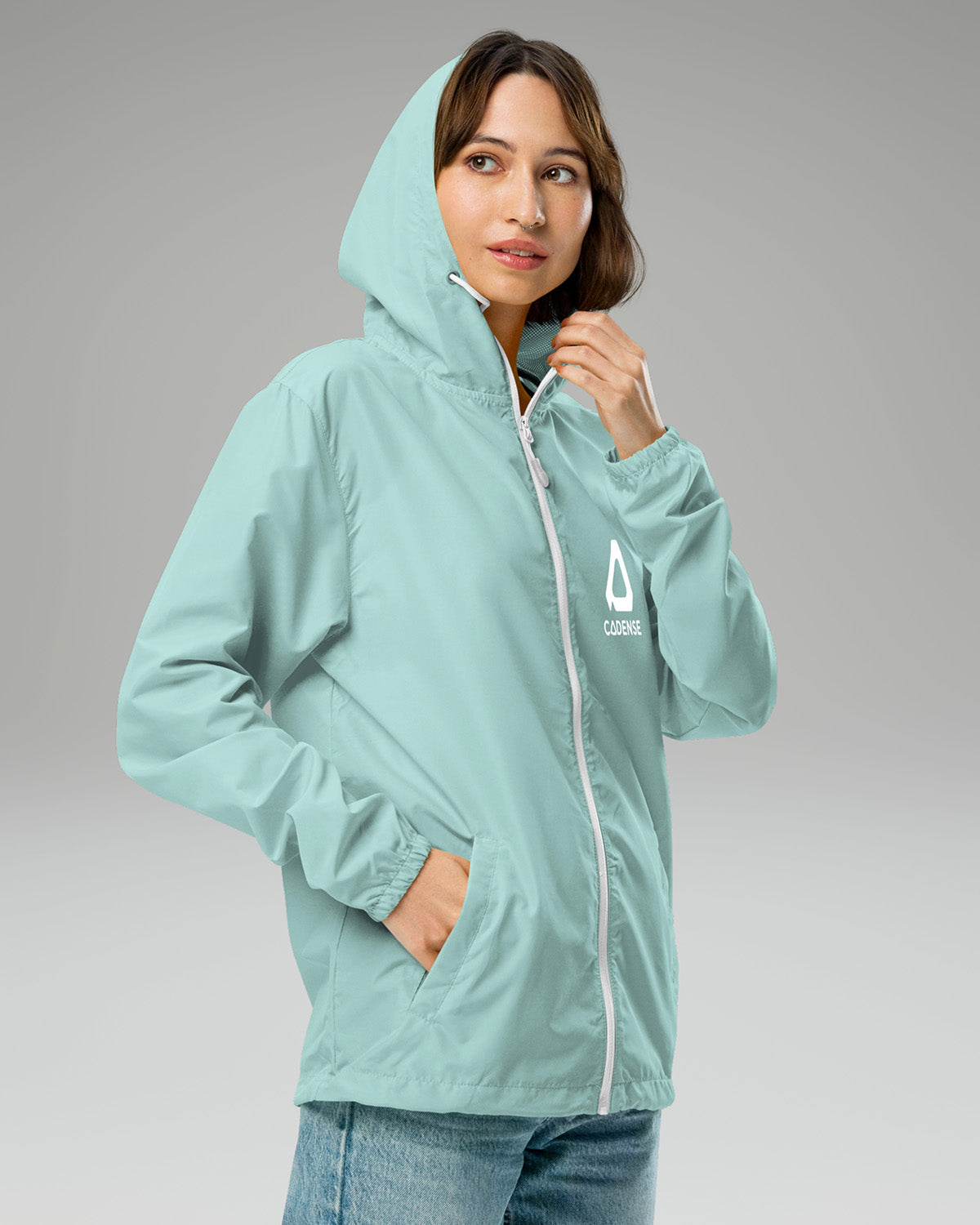 [color: aqua] Female model wearing aqua-colored Cadense Airwave Windbreaker.