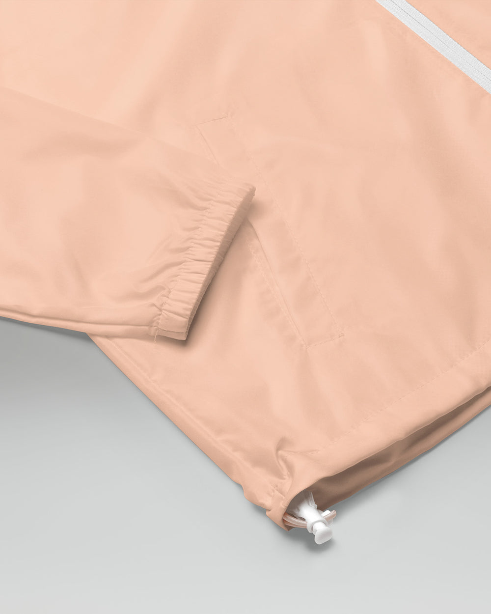 [color: blush] Sleeve of blush-colored Cadense Airwave Windbreaker.