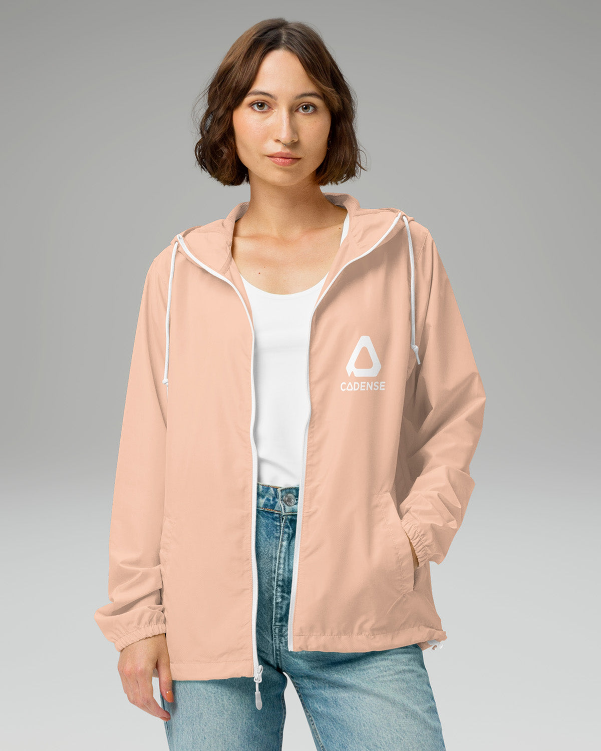 [color: blush] Female model wearing blush-colored Cadense Airwave Windbreaker.