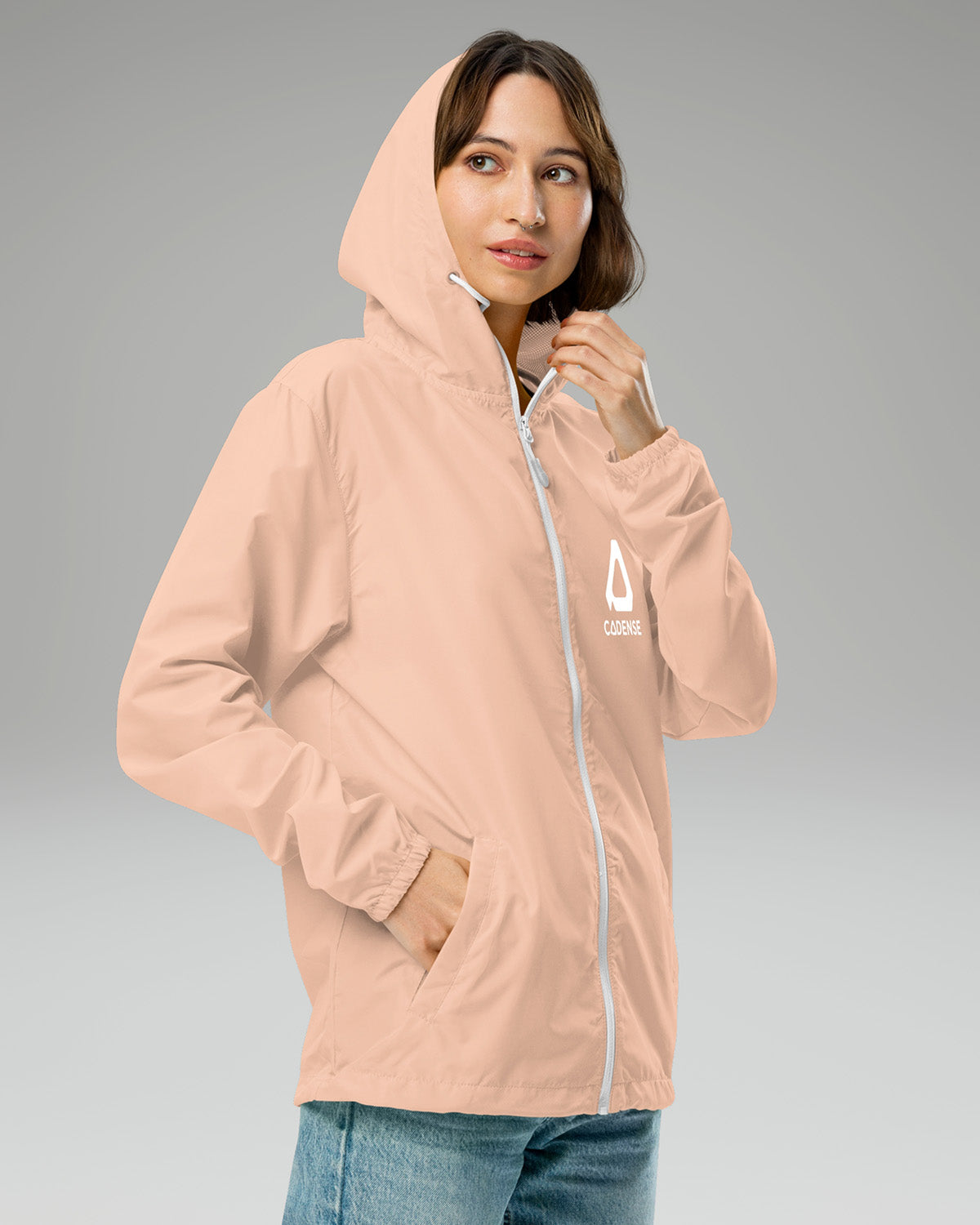 [color: blush] Female model wearing blush-colored Cadense Airwave Windbreaker.
