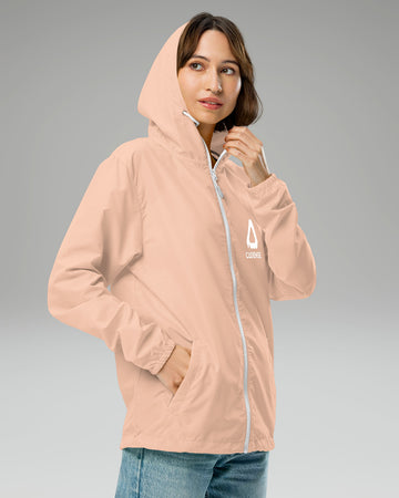 [color: blush] Female model wearing blush-colored Cadense Airwave Windbreaker.