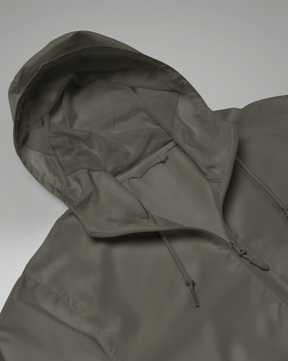 [color: graphite] Hood of Cadense Airwave Windbreaker on neutral background.