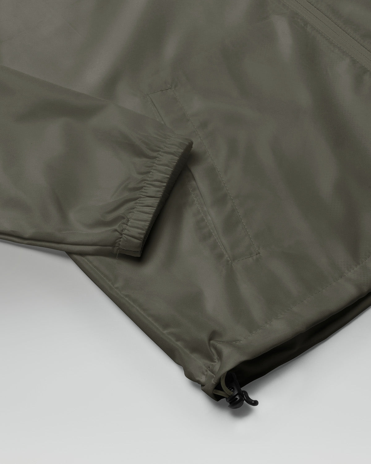 [color: graphite] Sleeve of Cadense Airwave Windbreaker on neutral background.