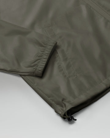 [color: graphite] Sleeve of Cadense Airwave Windbreaker on neutral background.