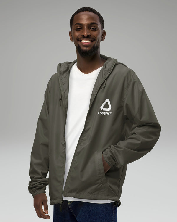 Young male adult wearing the graphite-colored Cadense Airwave Windbreaker.