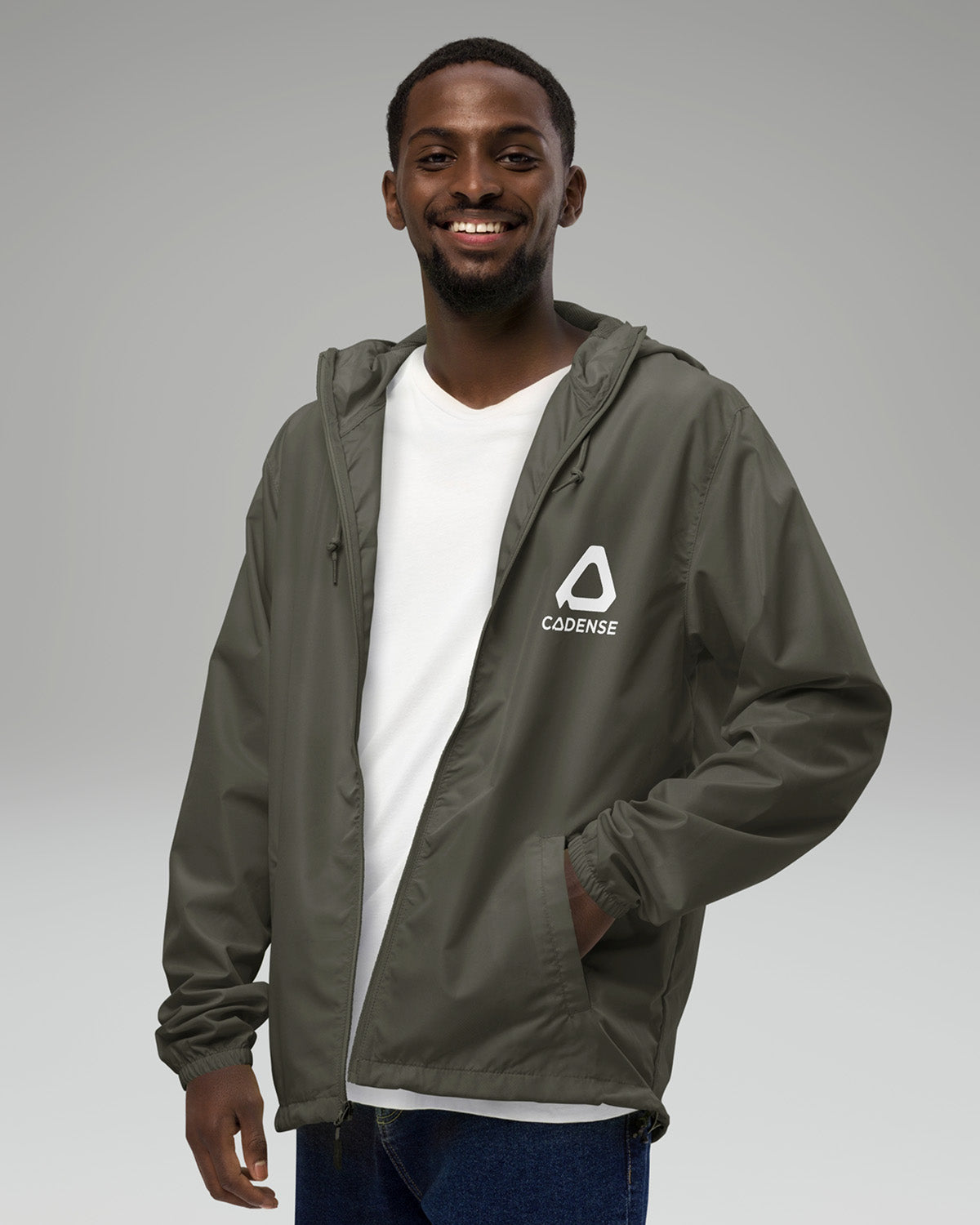 [color: graphite] Young male adult wearing the graphite-colored Cadense Airwave Windbreaker.