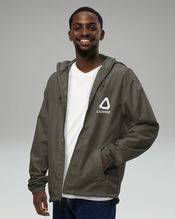 [color: graphite] Young male adult wearing the graphite-colored Cadense Airwave Windbreaker.