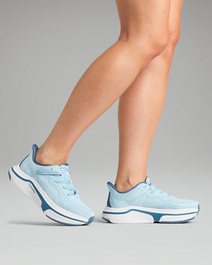 Woman wearing light blue sneakers