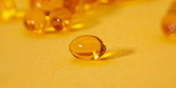 Close up of Yellow Pill on yellow background