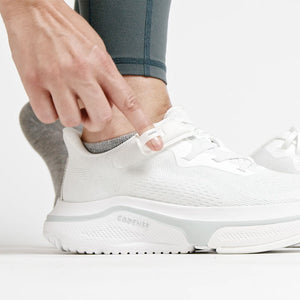 Woman opening the velcro of an adaptive shoe