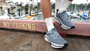 Men standing on pier with slate adaptive sneakers