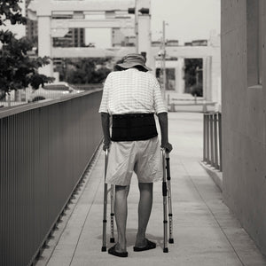 Older gentleman walking with a walker