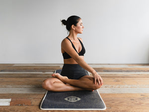 Woman doing a Seated Stretch on Yoga Mat