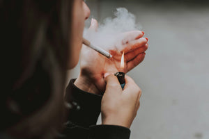 Woman lighting a cigarette