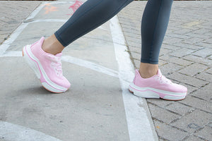 Woman walking in pink adaptive shoes outdoors