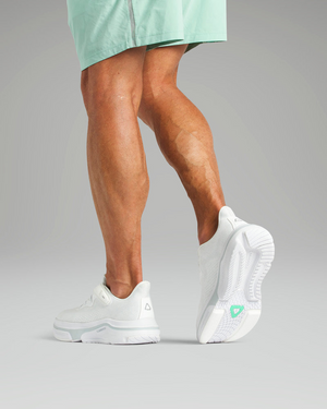 Young male adult wearing white Cadense Adaptive Sneakers