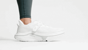 Woman putting on white Cadense Original shoes