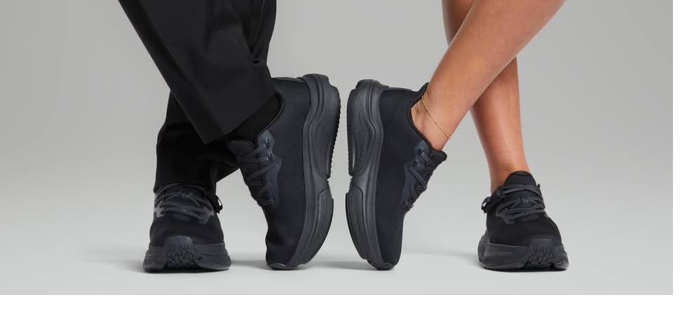 Two people walking side by side wearing Cadense adaptive shoes