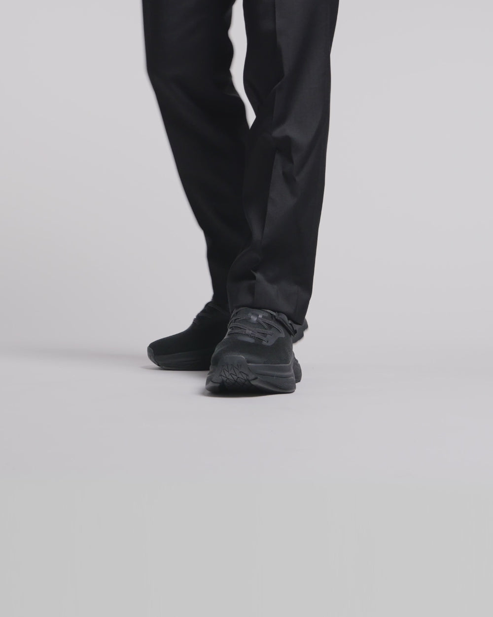 Man wearing all black adaptive shoes