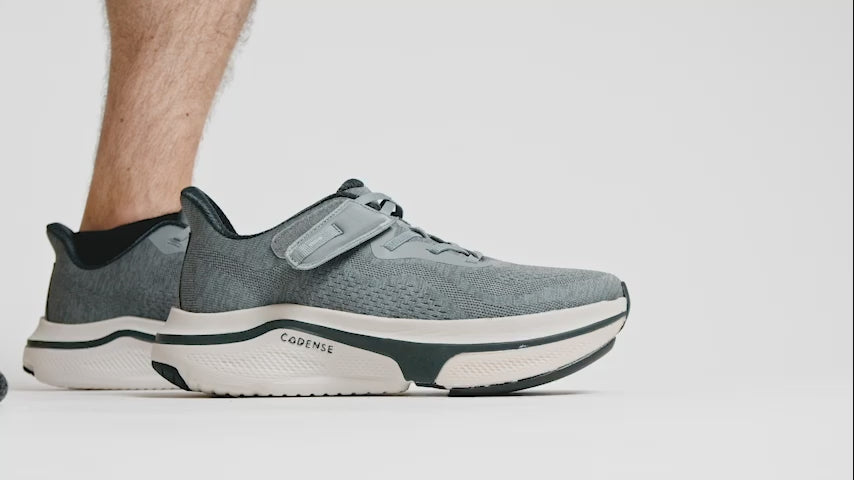 man putting on cadense original adaptive shoes
